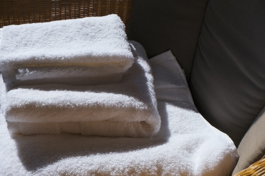 Folded white towels in soft window light